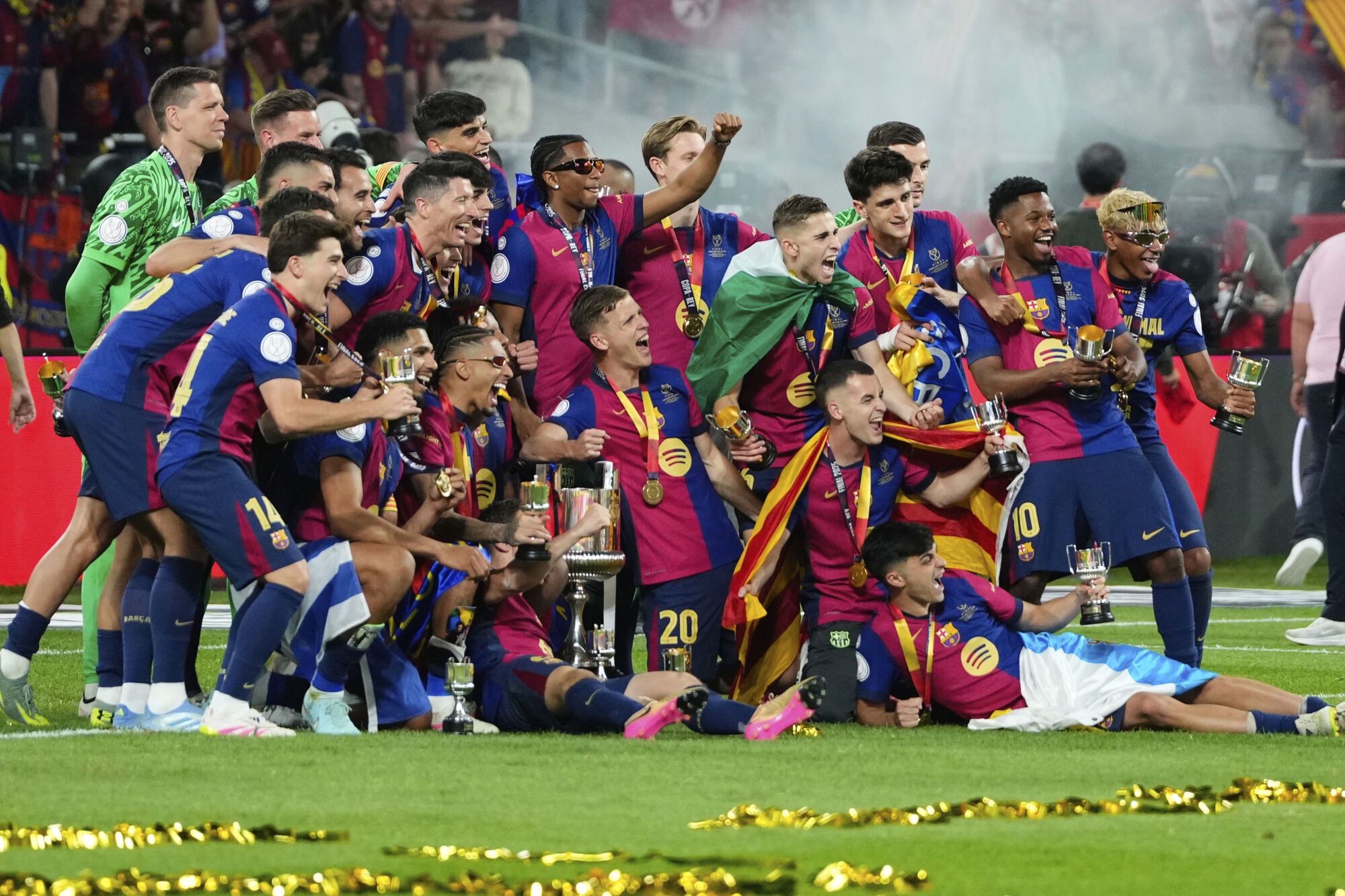 Barcelona players celebrate after winning the Spanish Copa del Rey final soccer match between Barcelona and Real Madrid at Estadio de La Cartuja stadium in Seville, Spain, Sunday, April 27, 2025. (AP Photo/Jose Breton)