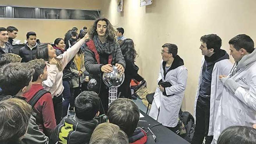 Los pelos de un joven se van erizando mediante el curioso generador de Van de Graaff.