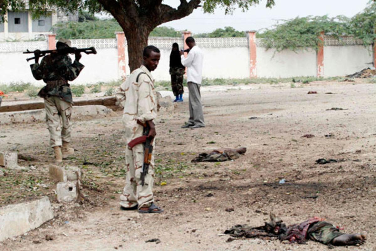 Soldats somalis observen les restes d’un atac suïcida a Villa Baidoa, a Mogadiscio (Somàlia).