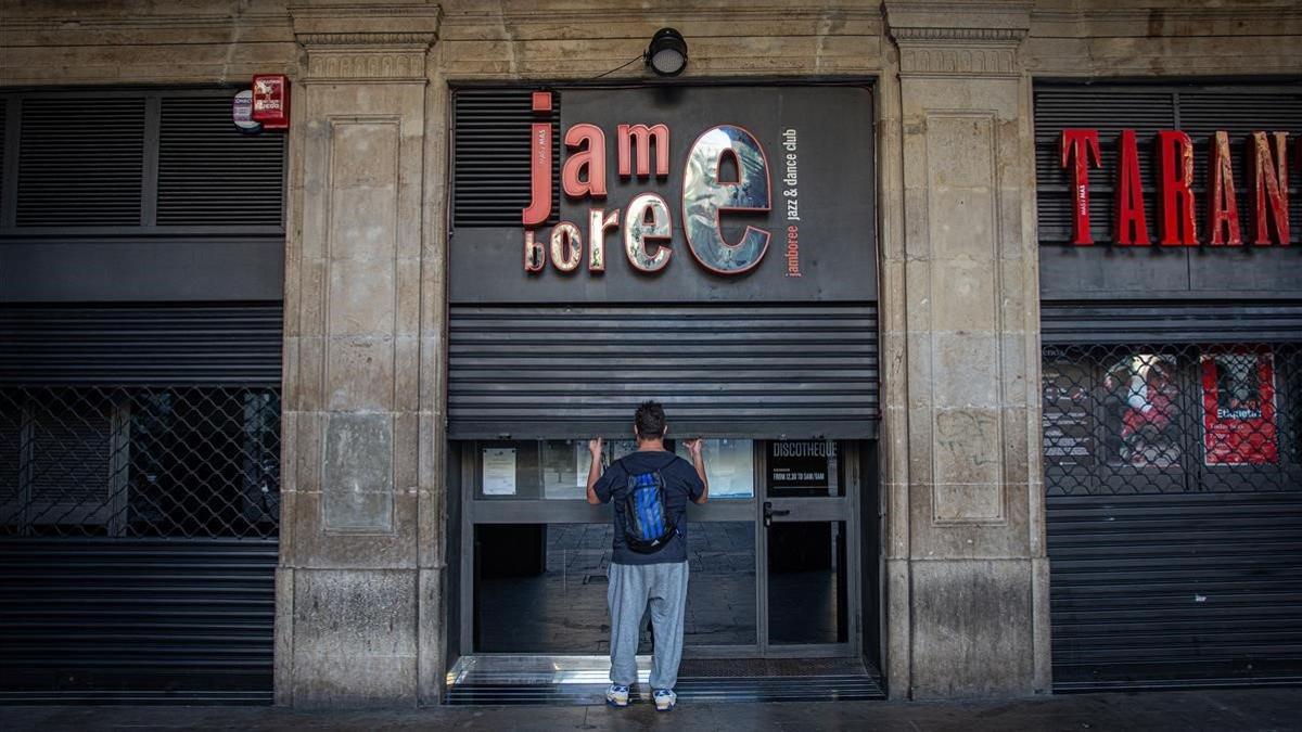 Ramón Sosa, encargado de la discoteca Jamboree de la Plaza Reial, cerrando la puerta.