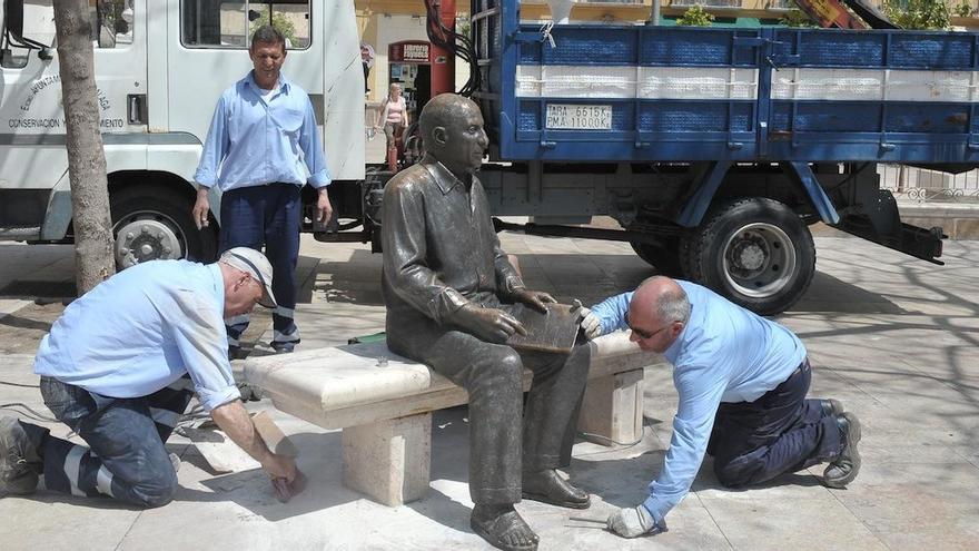 Trabajadores municipales recolocan la escultura de Picasso en la plaza de la Merced en 2013, después de que fuera arrancada por unos desconocidos.