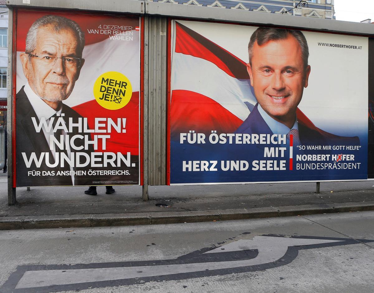 Presidential election campaign posters of Alexander Van der Bellen (L), who is supported by the Greens, reading Vote! Don’t be surprised. and of Norbert Hofer of the FPOe, reading For Austria with heart and soul, are seen in Vienna, Austria, December 4, 2016. REUTERS/Heinz-Peter Bader