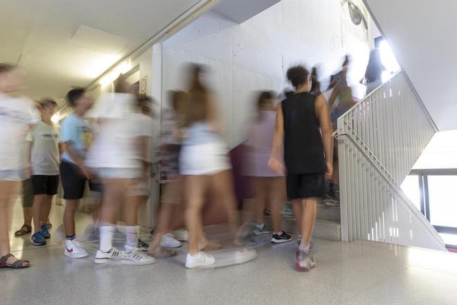 Alumnos en el pasillo y subiendo las escaleras de un instituto.
