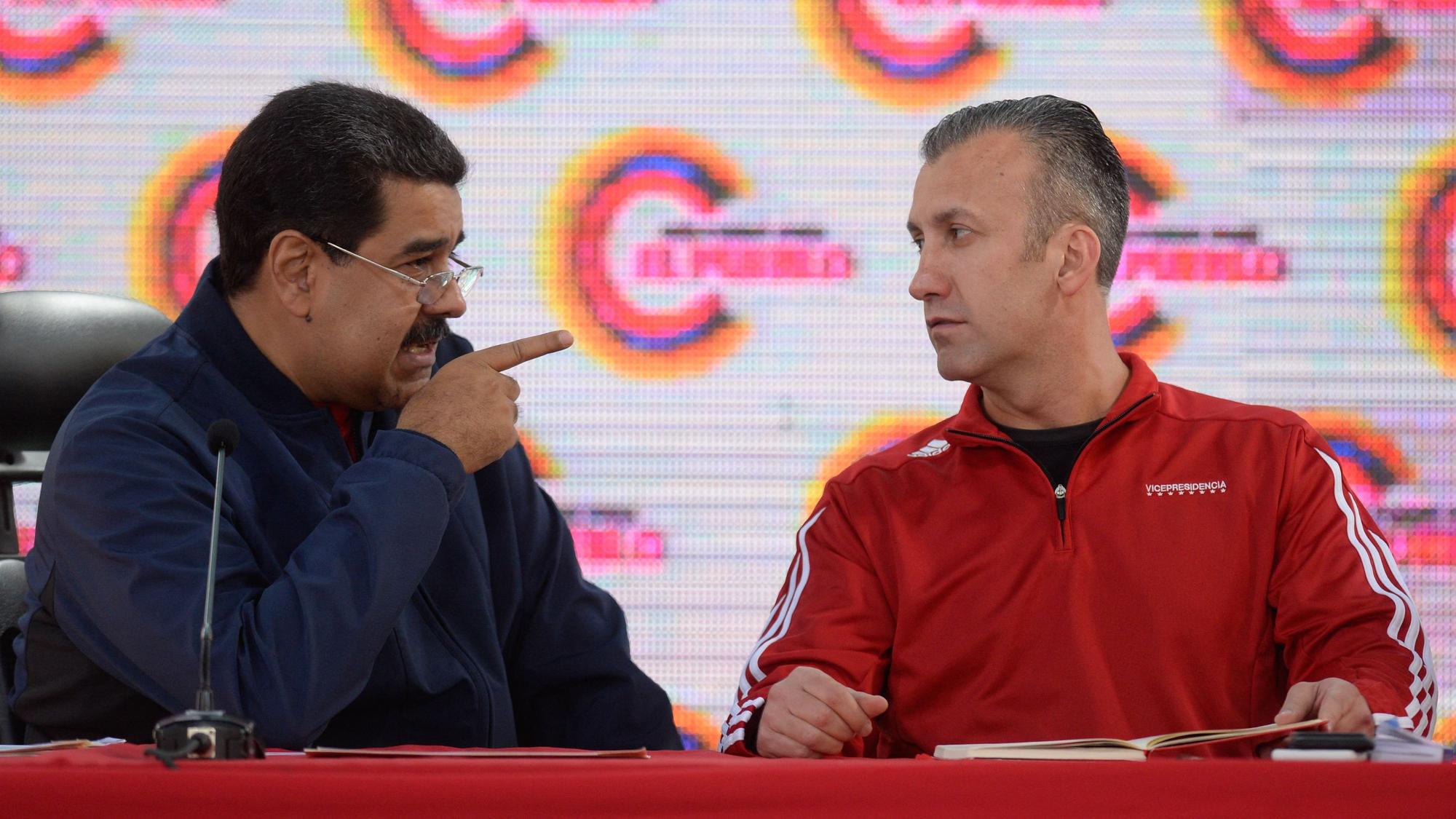 In this file photo taken on May 29, 2017, Venezuelan President Nicolas Maduro (L) talks with by Vice President Tareck El Aissami during the swearing in of the the members of the campaign command for the constituent assembly. - Venezuelan Oil Minister Tareck El Aissami resigned from his post on March 20, 2023, after a new investigation into corruption within the industry involving officials of state-owned PDVSA, for which a former manager has already been arrested, began over the weekend. (Photo by FEDERICO PARRA / AFP)
