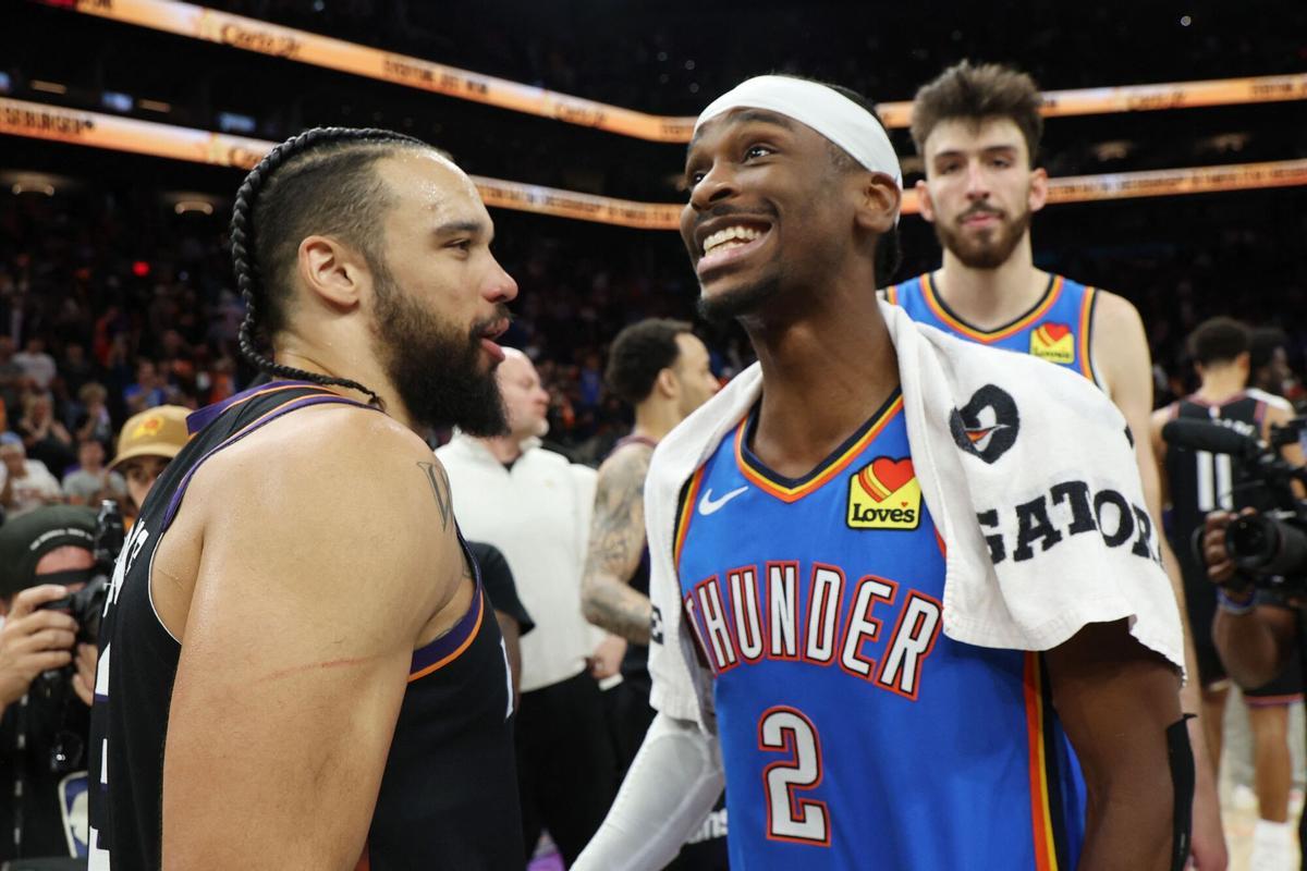 PHOENIX, ARIZONA - APRIL 27: Shai Gilgeous-Alexander #2 of the Oklahoma City Thunder and Dillon Brooks #3 of the Phoenix Suns come together after the Thunder victory in Game Four of the First Round of the NBA Western Conference Playoffs at Mortgage Matchup Center on April 27, 2026 in Phoenix, Arizona. NOTE TO USER: User expressly acknowledges and agrees that, by downloading and or using this photograph, User is consenting to the terms and conditions of the Getty Images License Agreement.   Christian Petersen/Getty Images/AFP (Photo by Christian Petersen / GETTY IMAGES NORTH AMERICA / Getty Images via AFP). NOTE TO USER: User expressly acknowledges and agrees that, by downloading and or using this photograph, User is consenting to the terms and conditions of the Getty Images License Agreement.
