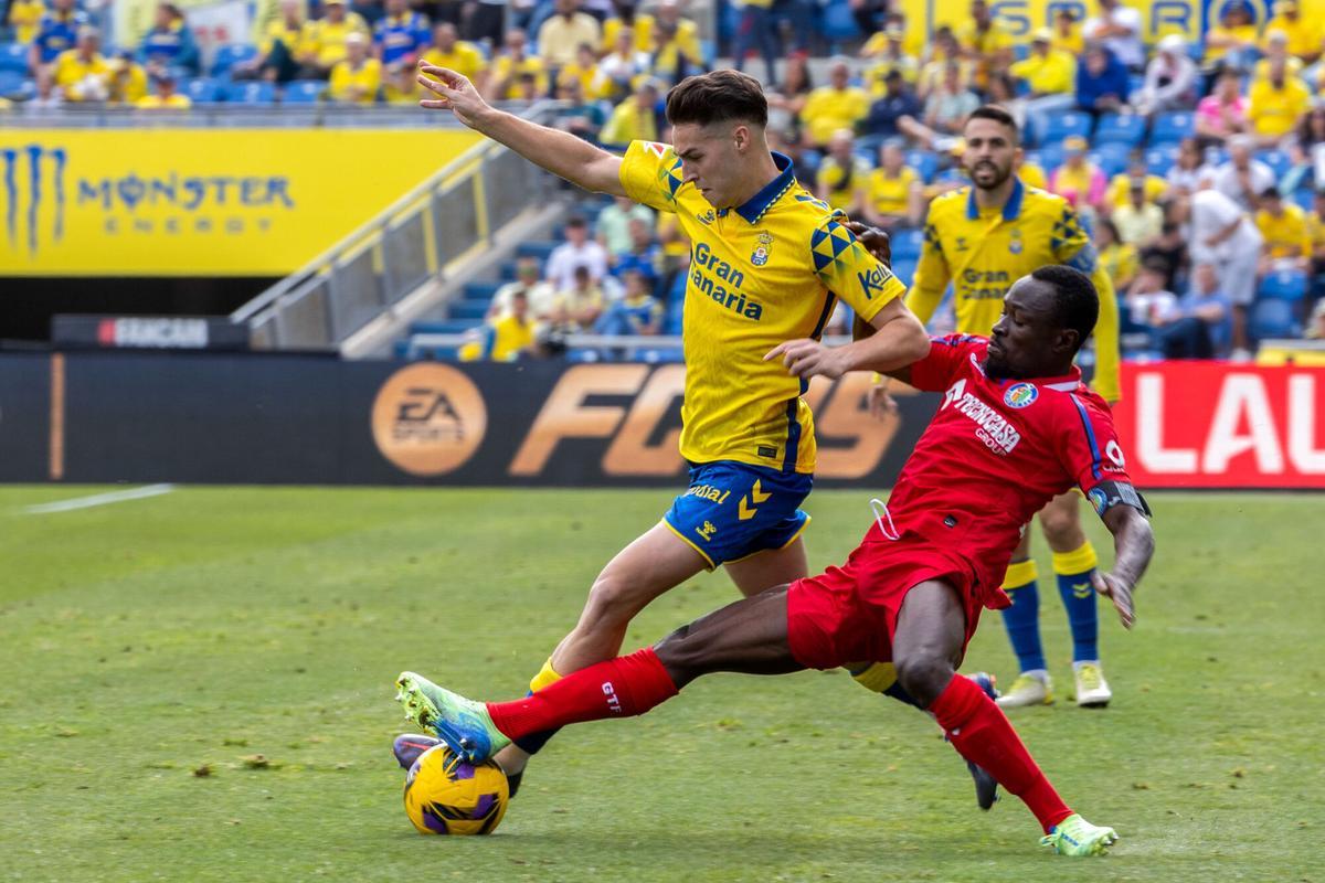 LAS PALMAS DE GRAN CANARIA (ESPAÑA), 12/01/2025.- El defensa de la UD Las Palmas, Mika Mármol (i) lucha por el balón con el defensa Djené Dakonam (d) del Getafe durante el partido correspondiente a la jornada 19 de LaLiga disputado este domingo en el estadio de Gran Canaria. EFE/ Quique Curbelo