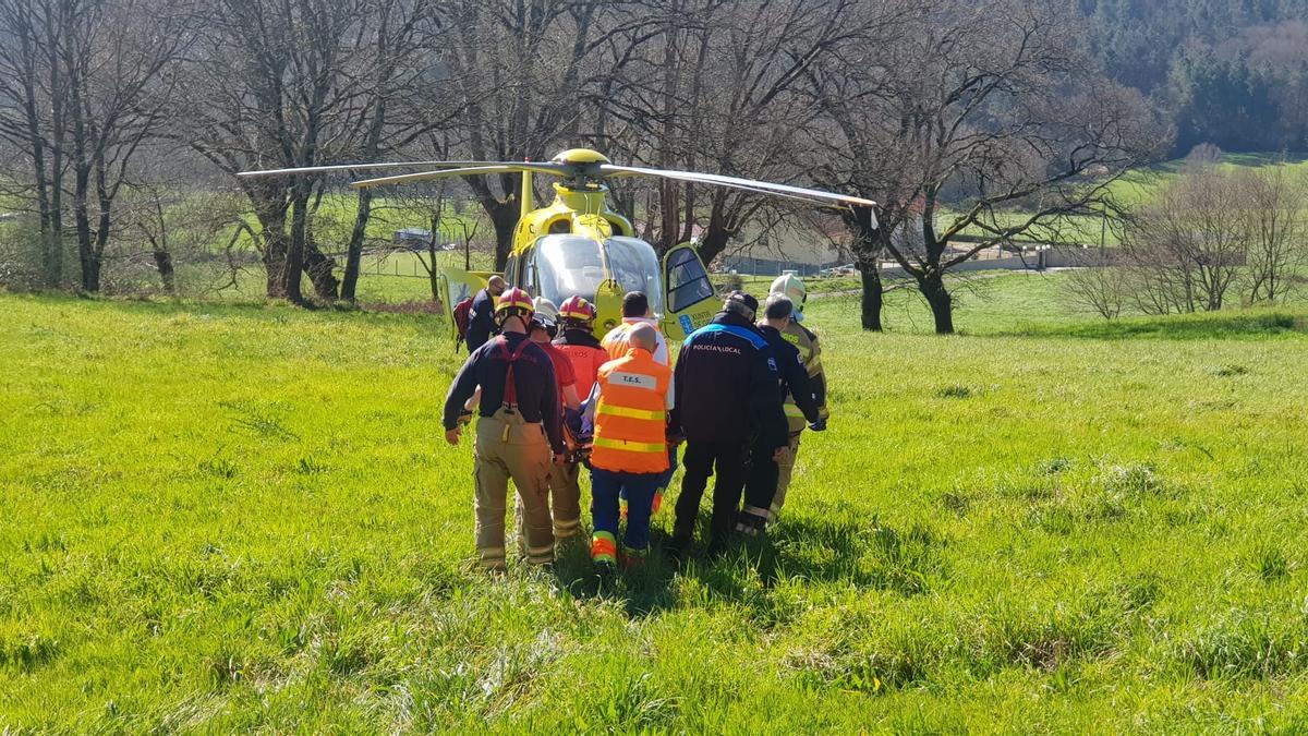 Bomberos, Policía local y Guardia Civil trasladan el herido hasta el helicóptero.// Bombeiros de Deza