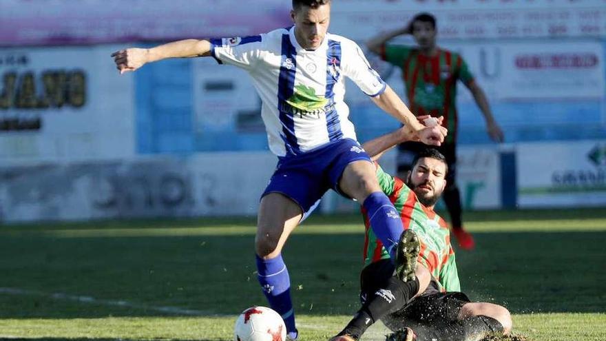 Un jugador del Areas trata de eludir a un rival durante un partido de Liga. // José Lores