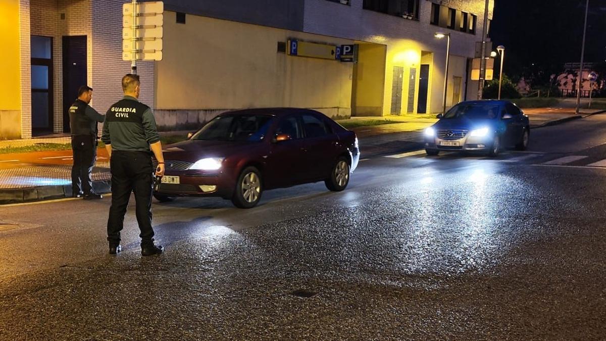Un control en Laviana ayer por la noche, con uno de los agentes con su arma en la mano | V. G.
