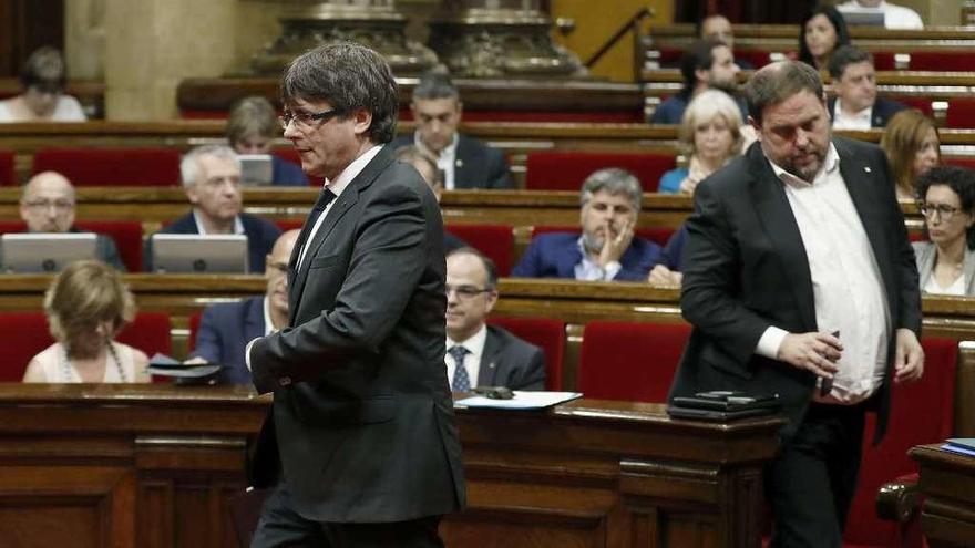 Puigdemont y Junqueras, ayer, en el pleno del Parlament. // Efe