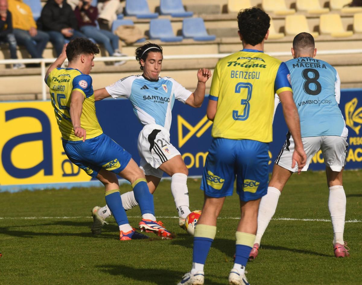 David Rosón y Jorge Maceira pugnan con el defensor cambadés por la posesión del balón.