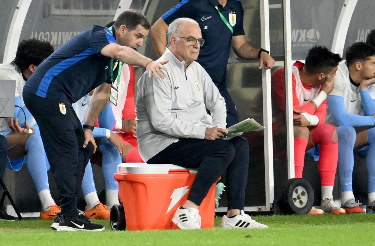 Uruguay head coach Marcelo Bielsa, seated, looks on during the second half of an international friendly soccer game against United States Tuesday, Nov. 18, 2025, in Tampa, Fla. (AP Photo/Jason Behnken)