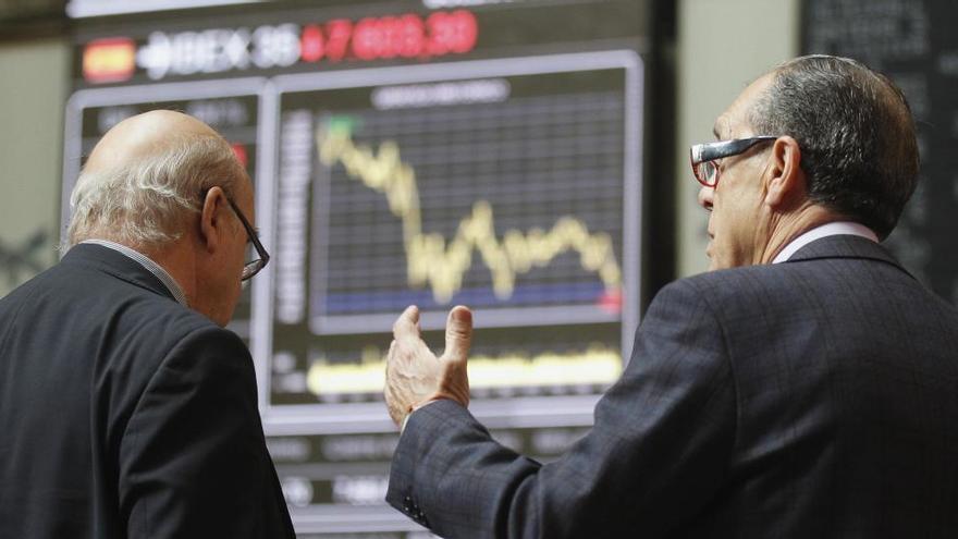 Dos inversors observen les pantalles de la Borsa de Madrid · REUTERS