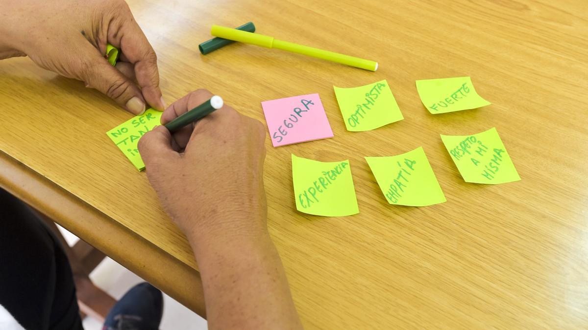 Un detalle de una de las actividades donde las mujeres escriben en un papel cómo ha sido su transformación.