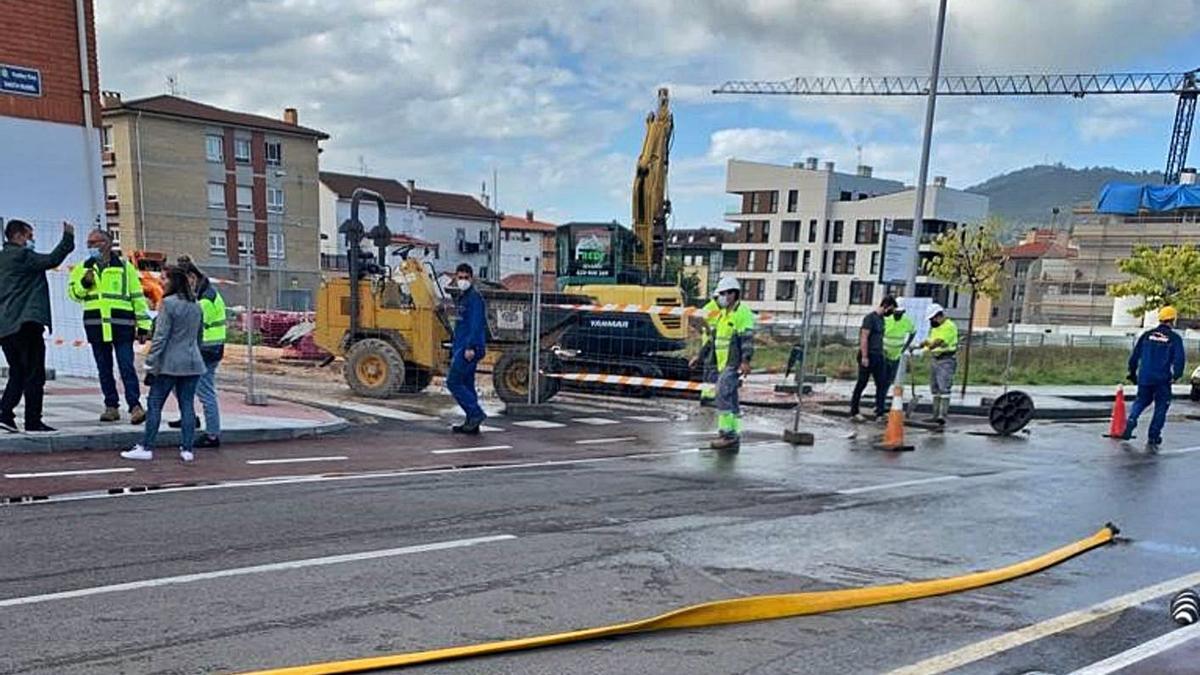 Operarios y vecinos, en la zona del incidente. A la derecha, los vehículos de emergencias. | |  A. I.