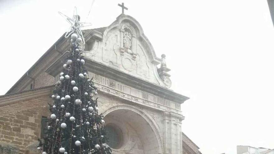 Un señor observa el árbol de Navidad, en la plaza de la Madera.