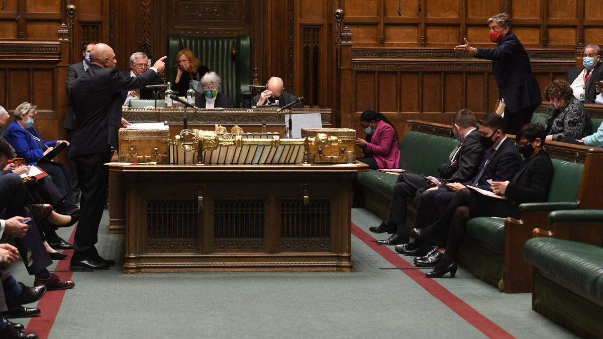 A handout photograph released by the UK Parliament shows Britain's Health Secretary Sajid Javid attending a debate ahead of a vote on the Government's planned measures to tackle the Omicron variant of Covid-19, in the House of Commons in London on December 14, 2021. - The British government on Tuesday urged its own MPs not to rebel against new coronavirus restrictions, insisting the country was in a race to prevent the Omicron variant spiralling out of control. Prime Minister Boris Johnson is facing potentially the largest backlash from within his own ranks since he won an emphatic election victory in December 2019, putting him under further pressure after a string of recent scandals. (Photo by JESSICA TAYLOR