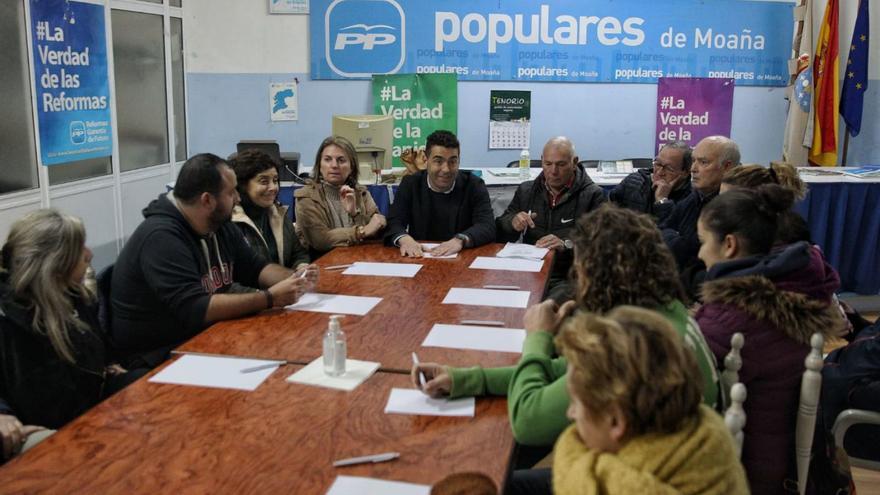 Luis López, al frente de la mesa, en la reunión con la junta local del PP de Moaña en su sede. |   // S.Á.