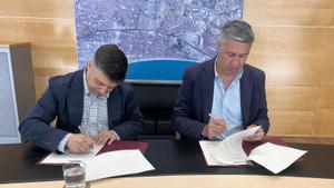 El nuevo gerente del Ayuntamiento de Badalona, Jofre Clofent Calsapeu, firma su contrato junto al alcalde Albiol