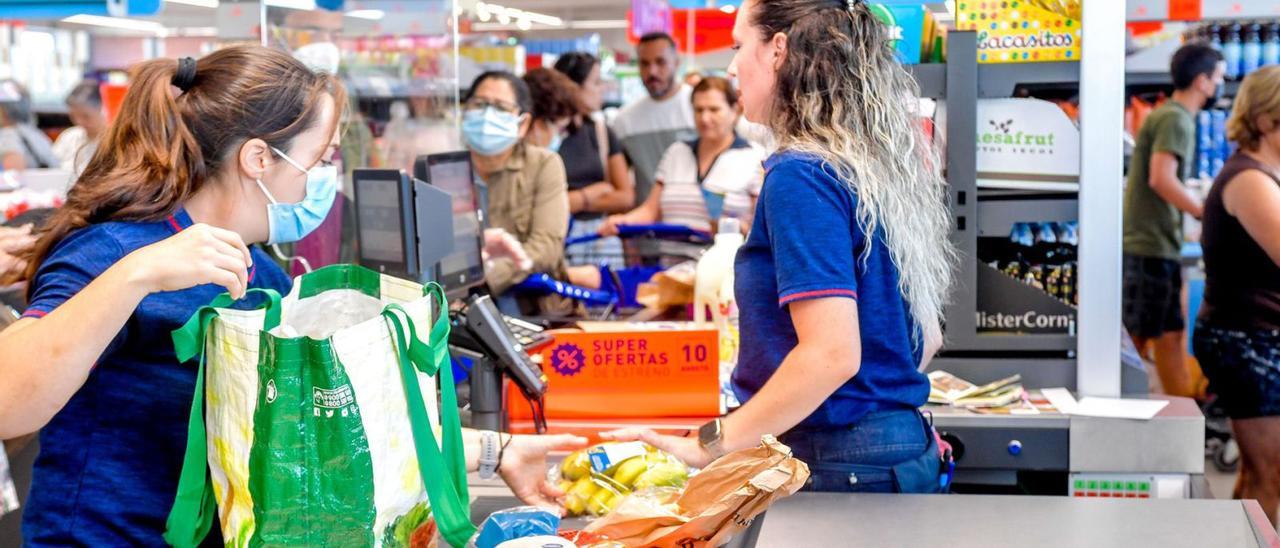 Una cajera pasa la compra de una clienta en un supermercado del Archipiélago. | | JUAN CARLOS CASTRO