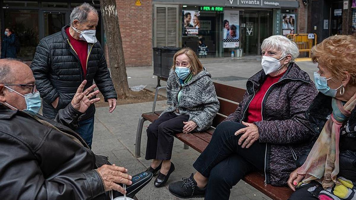 Varias personas mayores conversan.