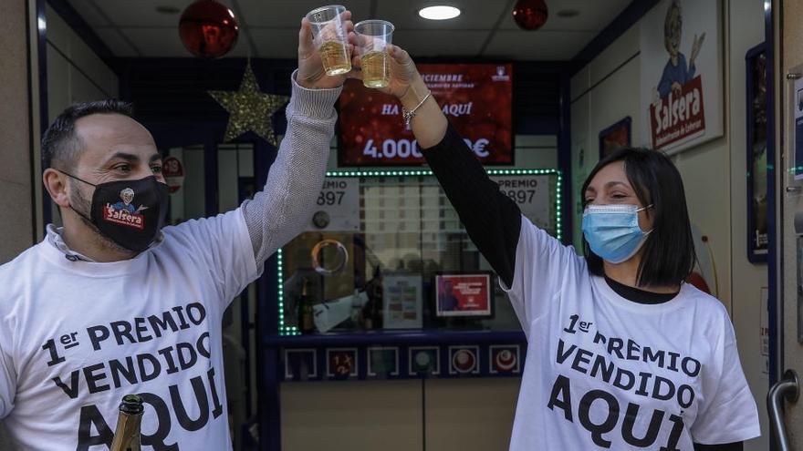 Dos loteros celebran El Gordo con champán en una administración de lotería de Valencia
