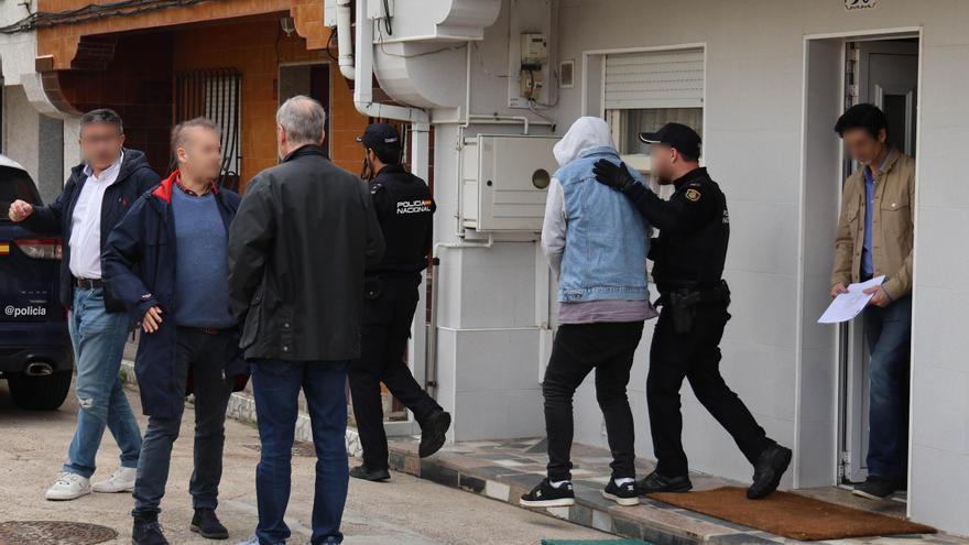 El detenido, a la derecha escoltado por policías.