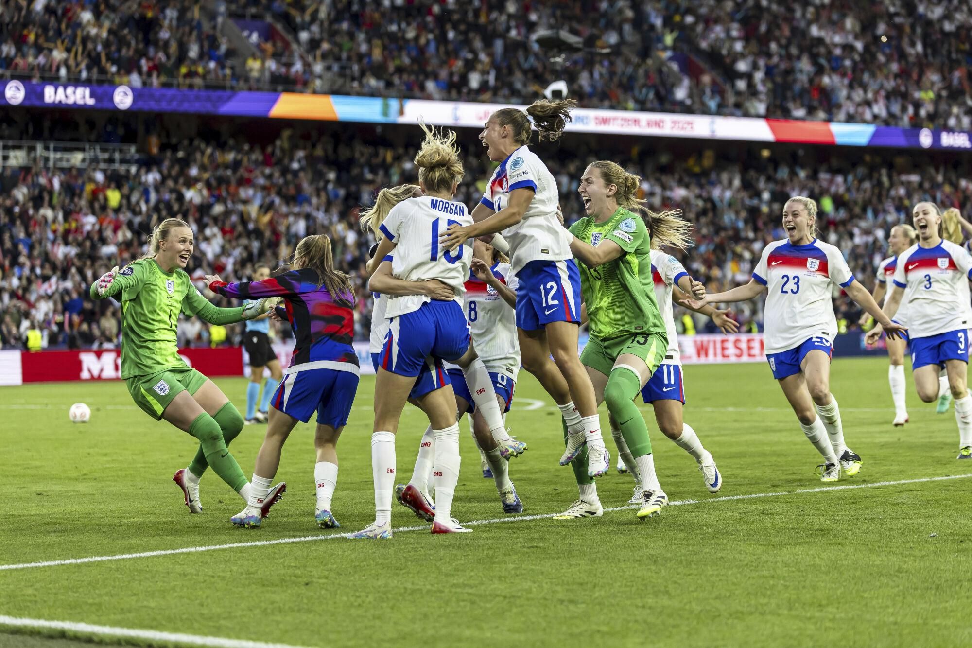 England celebrates after Chloe Kelly scoed to win the penalty shoot-out after the Women's Euro 2025 final soccer match between England and Spain at St. Jakob-Park in Basel, Switzerland, Sunday, July 27, 2025. (Michael Buholzer/Keystone via AP). EDITORIAL USE ONLY