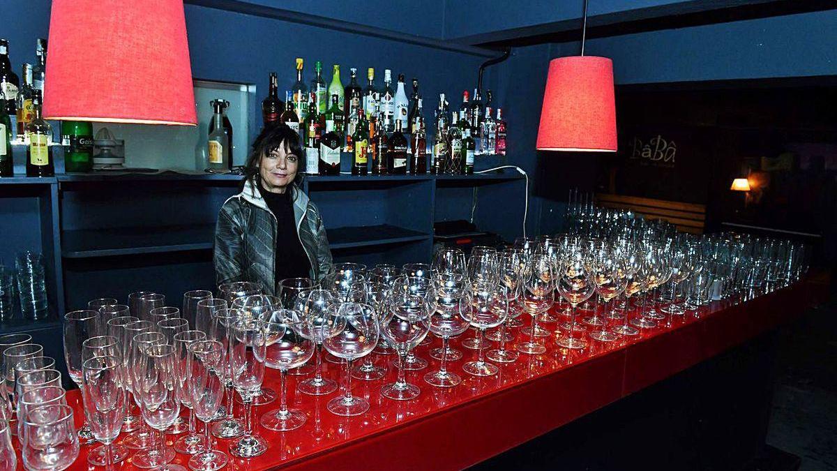 Cristina Toba, ayer, en la sala Bâbâ Bar, con copas que ha puesto a la venta por el cierre.