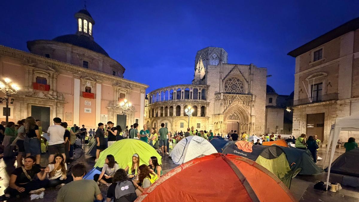 Decenas de personas acampan en plena plaza de la Virgen de València en apoyo a la huelga educativa.