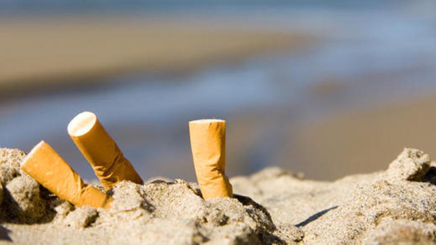 Tres colillas de cigarrillos en la playa.