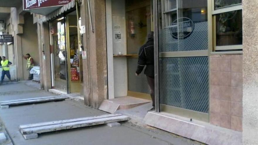 Los tablones instalados ayer a la entrada de los comercios y las viviendas en Ciudad Jardín.