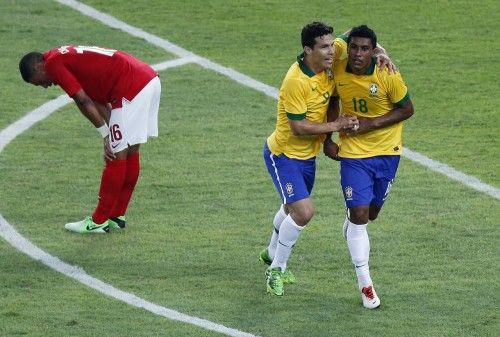 Brazil's Paulinho celebrates his goal with Hernanes next to England's Oxlade-Chamberlain during their international friendly soccer match at the Maracana Stadium in Rio de Janeiro