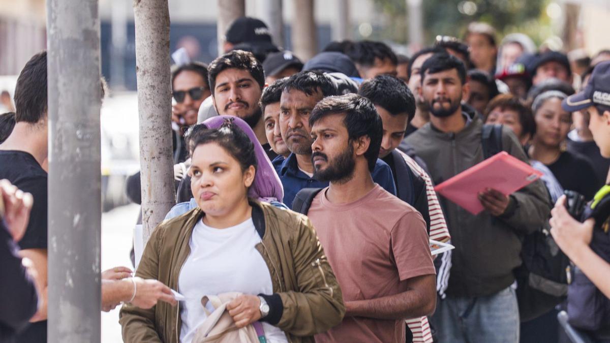 Cues de persones immigrants per tramitar la regularització, a la seu de l’Ajuntament de Barcelona. | MARC ASENSIO CLUPÉS