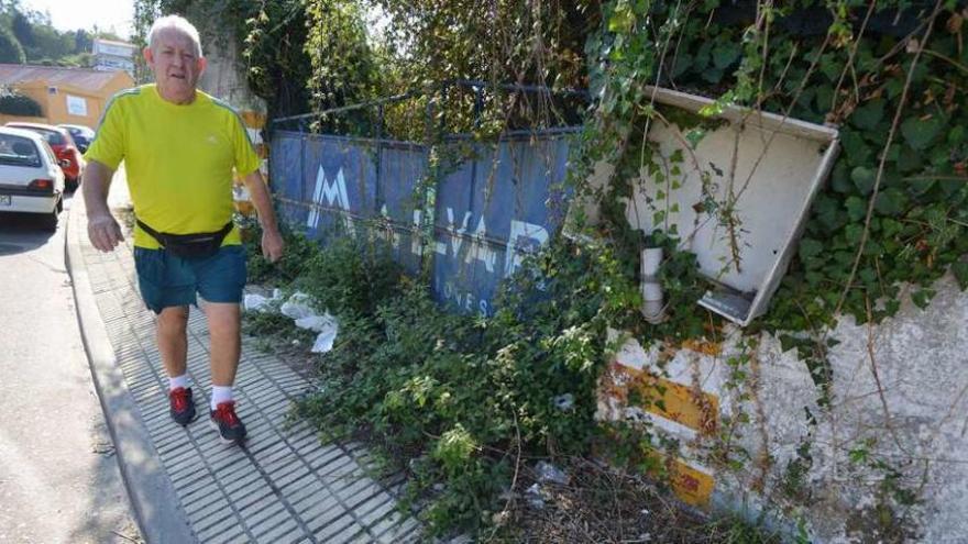 Un vecino pasa ante uno de los accesos a la finca de Malvar, en Mollabao. // Gustavo Santos