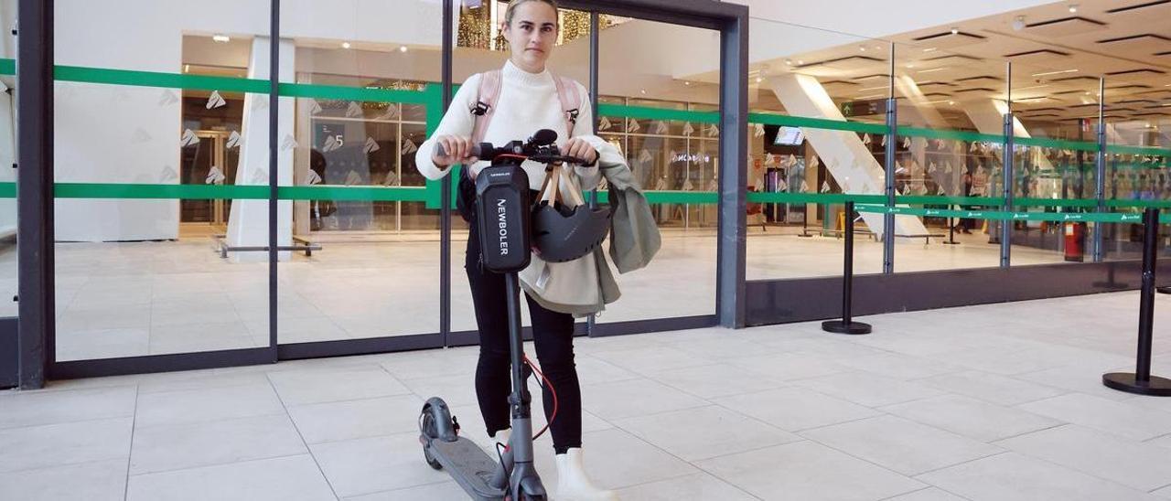 La viguesa Candela Puime, con su patinete eléctrico en la estación de tren de Vigo-Urzáiz