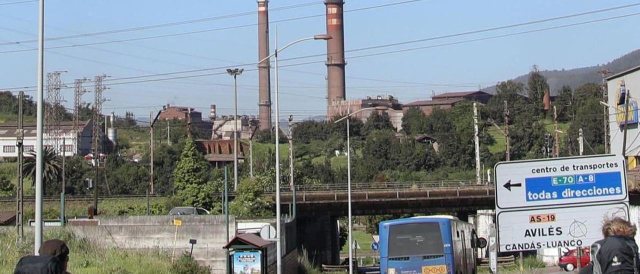 Al fondo, en el centro, chimeneas de los hornos de los dos sínter de Arcelor, la del B a la derecha, vistas desde la carretera de Avilés. | Marcos León