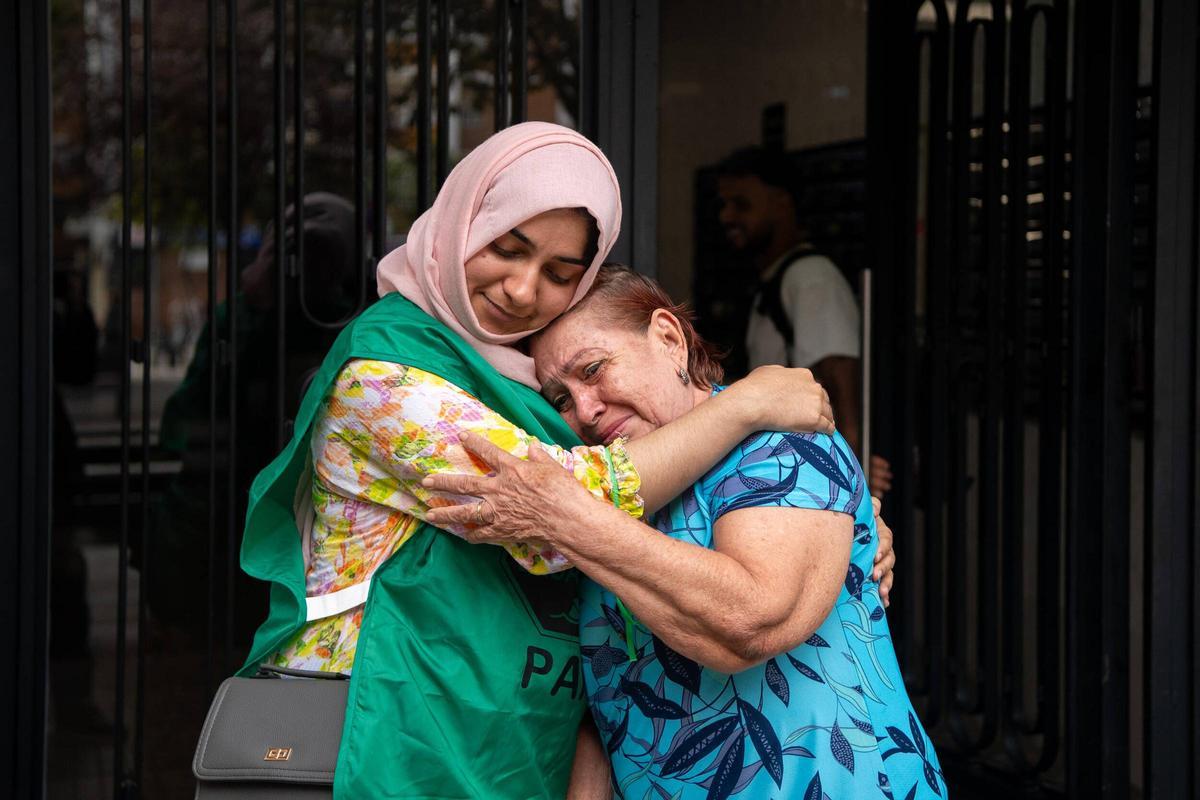 Una vecina (Rosalma) abraza a Sehar Iman tras conocer la suspensión de su desahucio en el barrio de Sant Ildefons de Cornellà.