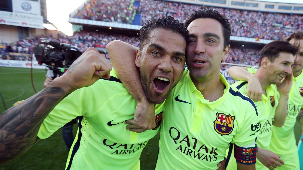 Xavi Hernández y Dani Alves celebran el título de liga 2014-2015