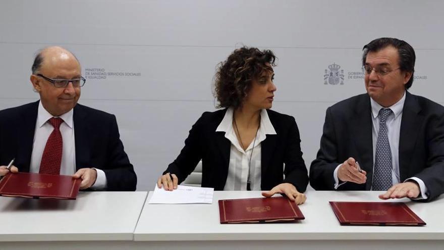 La ministra Dolors Monstserrat; Cristóbal Montoro (i.) y el presidente de Farmaindustria , Jesús Acebillo, durante la firma del convenio.