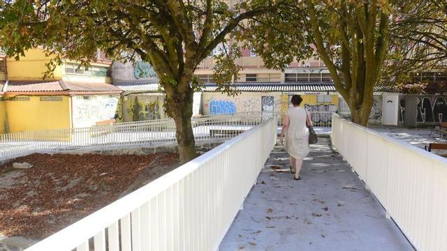 Una mujer, en la nueva pasarela del Barrio de las Flores que se acaba de construir para los vecinos de Margaritas. | Casteleiro/Roller Agencia