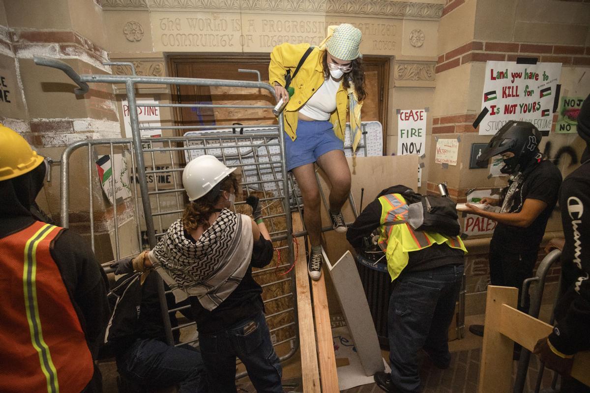 Pro-Palestinian demonstrators block the entrance to a building on the UCLA campus Wednesday, May 1, 2024, in Los Angeles. (AP Photo/Ethan Swope)