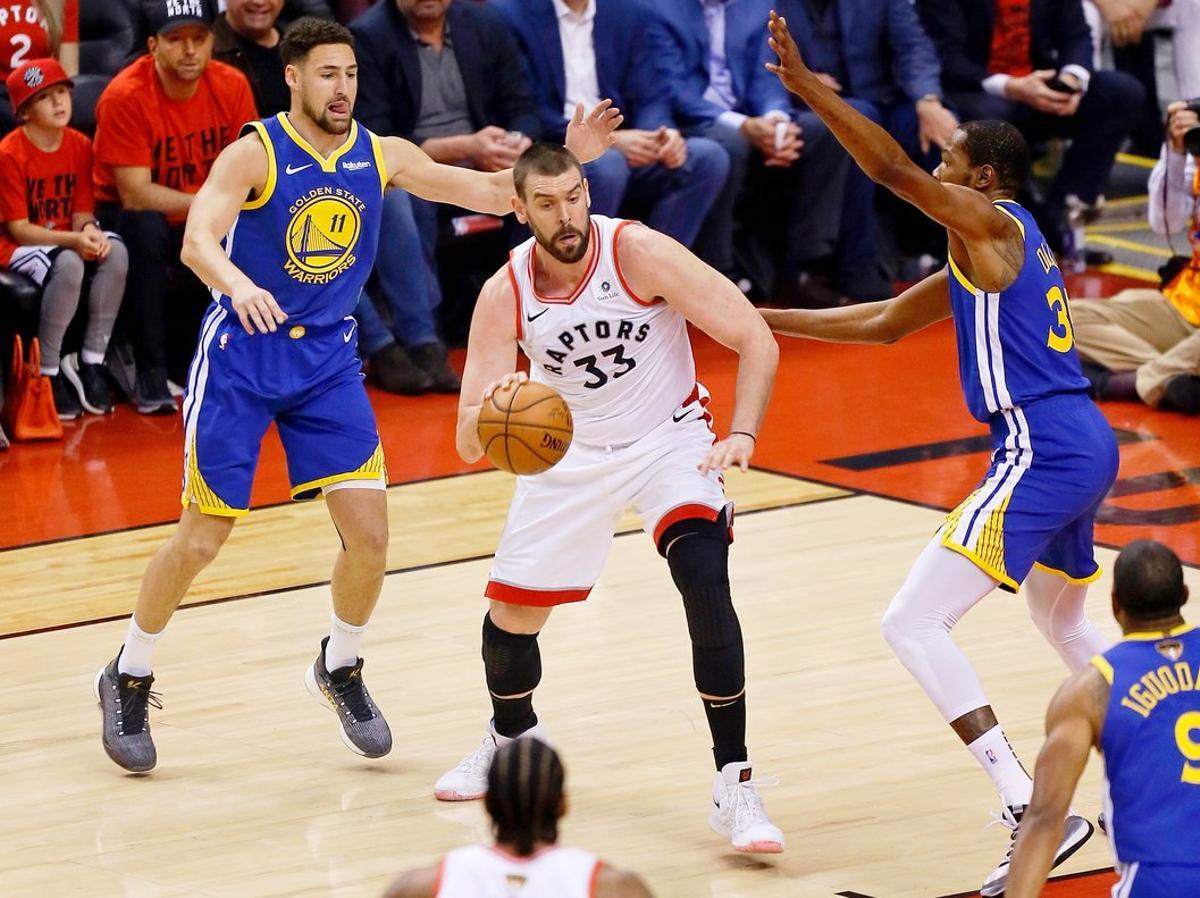 Jun 10, 2019; Toronto, Ontario, CAN; Toronto Raptors center Marc Gasol (33) dribbles the ball while defended by Golden State Warriors guard Klay Thompson (11) and forward Kevin Durant (right) during the first quarter in game five of the 2019 NBA Finals at Scotiabank Arena. Mandatory Credit: John E. Sokolowski-USA TODAY Sports