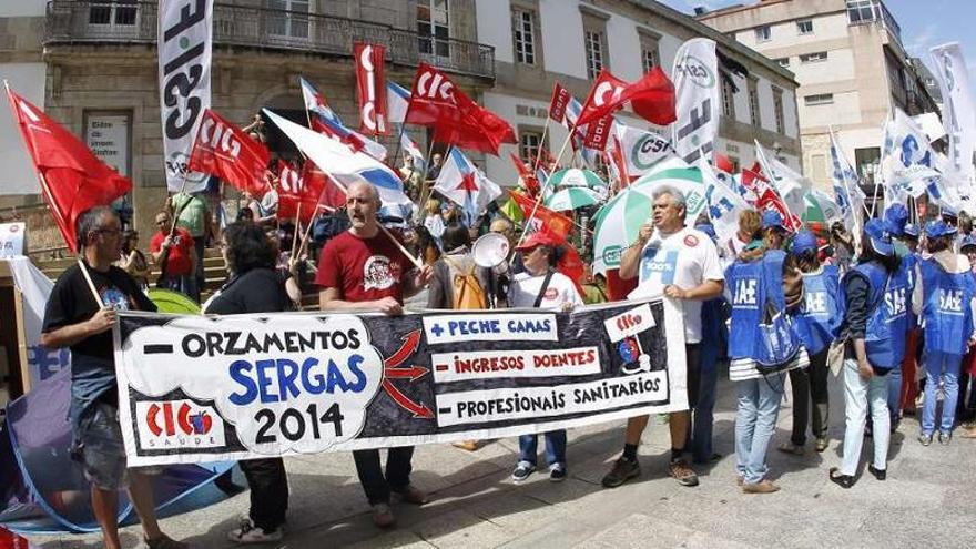 Arriba, la concentración en la calle Príncipe. Abajo, tres trabajadoras simulan ser pacientes desatendidos.