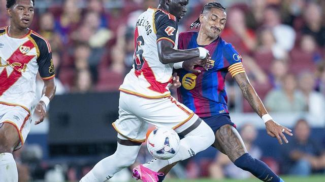 Raphinha topa amb Pathe Ciss en el partit d’ahir al Camp Nou. | JORDI COTRINA