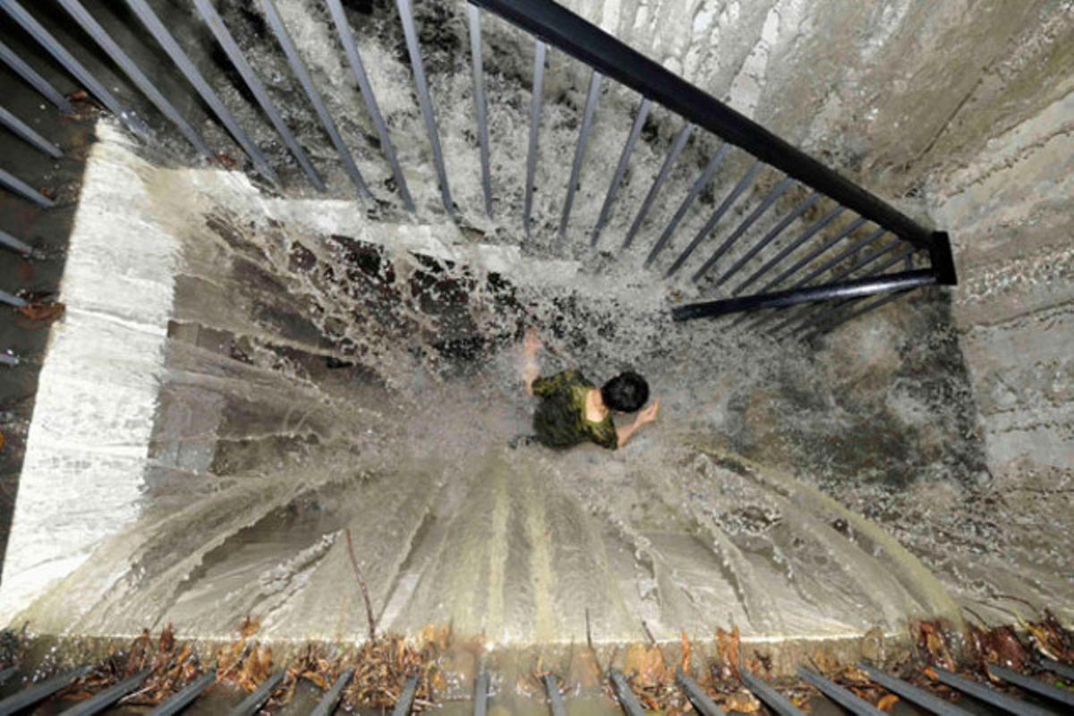 Un home corre per les escales inundades d’un garatge subterrani, a Chengdu, a la província xinesa de Sichuan.