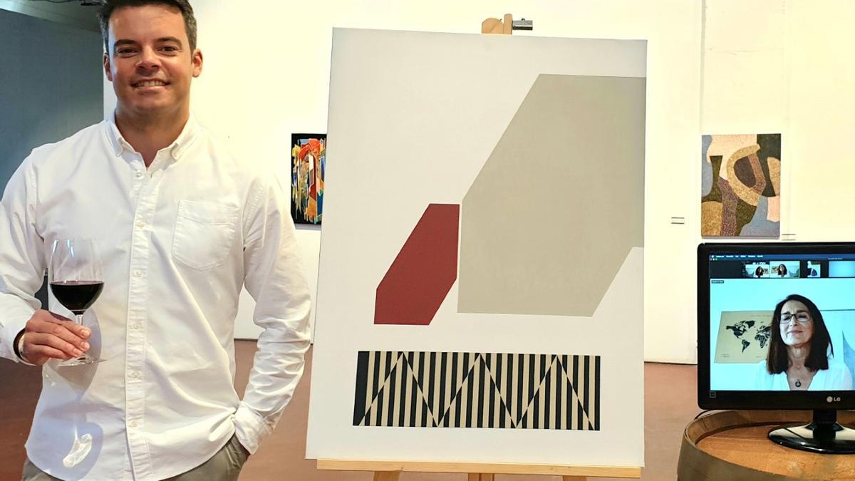 Manu Fariña posa con la obra que ilustrará la etiqueta del vino más joven de la bodega