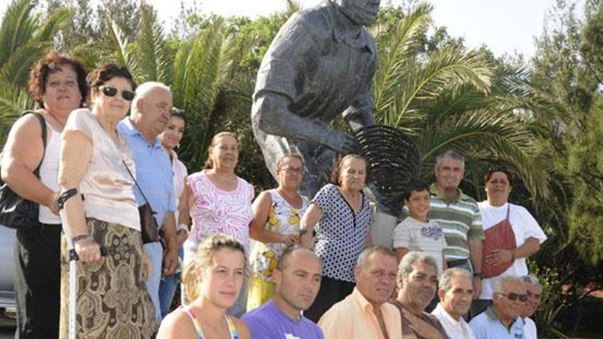 Vecinos junto a la escultura en honor a la pesca de la lisa, que desde ayer luce a la entrada del Charco. i LP/DLP