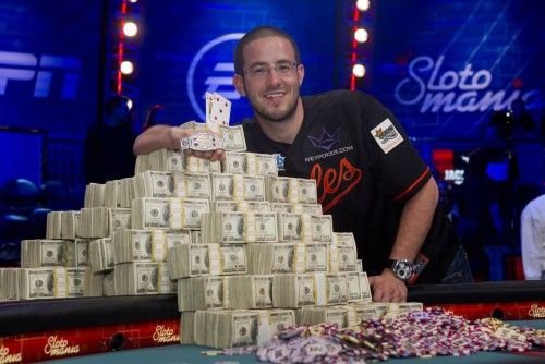Greg Merson, 24, of Laurel, Maryland poses with stacks of cash and his championship bracelet after winning the World Series of Poker Main Event in Las Vegas