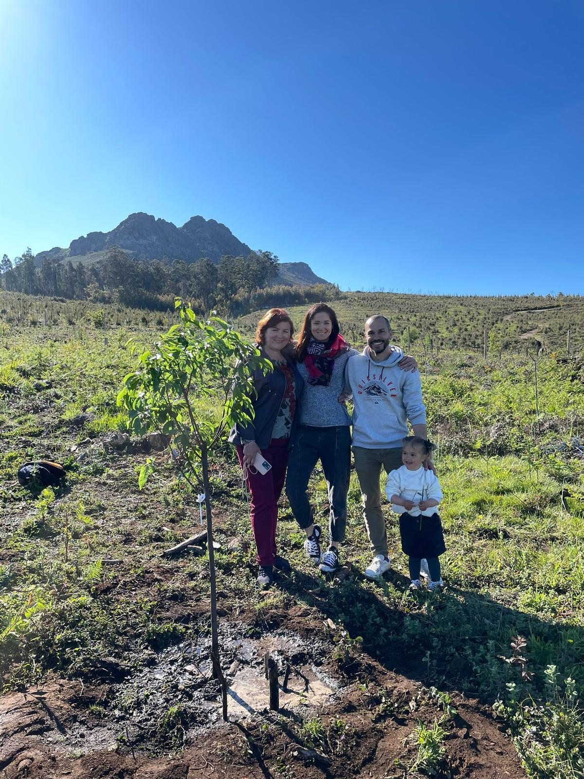 La familia posa junto al árbol recién plantado para conmemorar el segundo cumpleaños de Sofi.